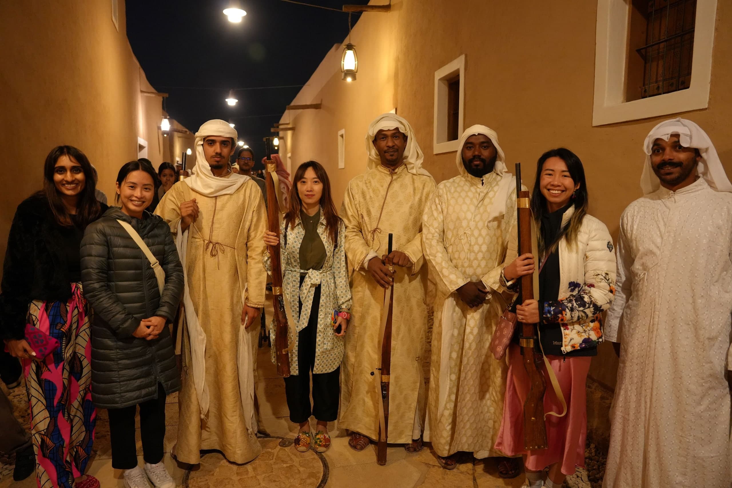 Students interacting with young Saudi guides during their trip